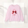 Feminine & Flirty sweatshirt with red satin bow design on Gildan 18000 - Light Pink Flatlay