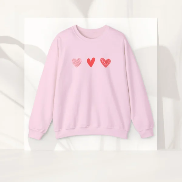 Three Hearts sweatshirt with red hearts design on Gildan 18000 - Light Pink Flatlay
