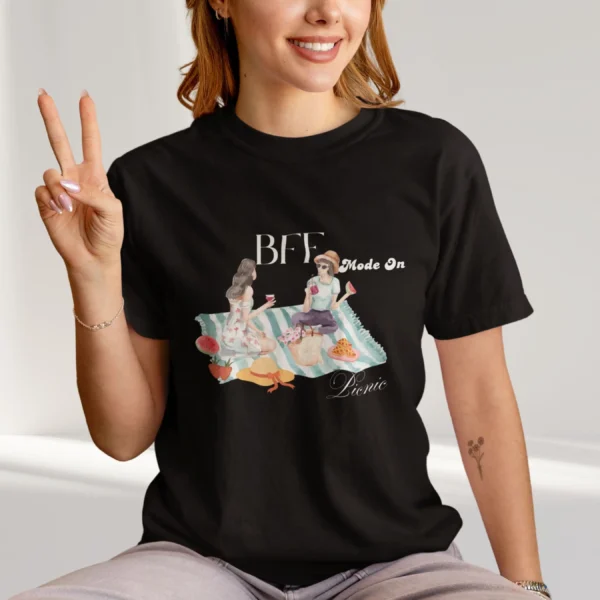 BFF Mode On Tee with watercolor illustration of two girls enjoying a picnic with fruit, waffles, a basket & drinks on striped blanket on Comfort Colors 1717 - Black