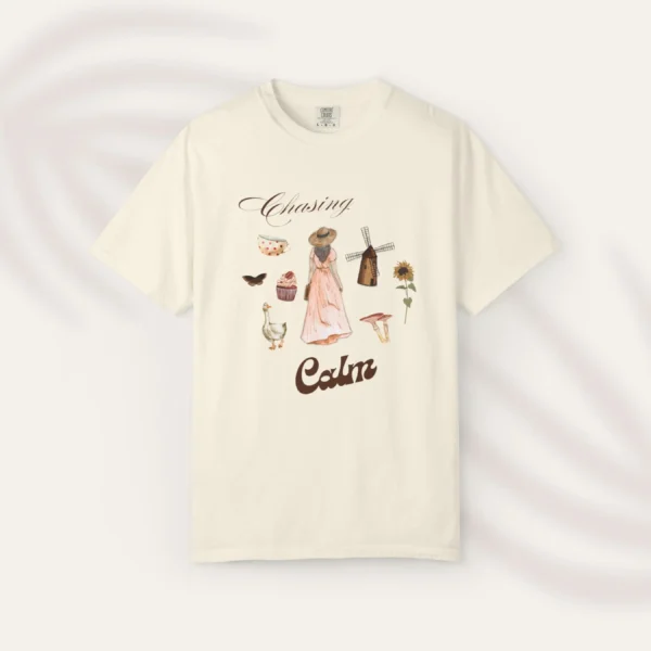 Chasing Calm Tee with cottage girl, geese, florals, and windmill on Comfort Colors 1717 - Ivory Flatlay