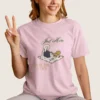 Just Here for the Cozy Tee 1717 with illustration of a girl enjoying picnic on Comfort Colors 1717 - Blossom