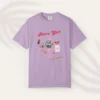 Graphic T-shirt with "Retro Girl" text in pink, paired with disco ball, lipstick, purse, martini glass, and cassette on Comfort color 1717 - Orchid Flatlay
