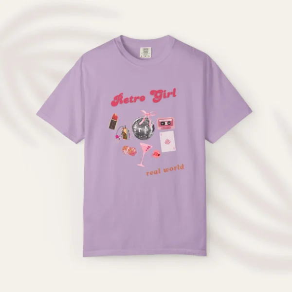 Graphic T-shirt with "Retro Girl" text in pink, paired with disco ball, lipstick, purse, martini glass, and cassette on Comfort color 1717 - Orchid Flatlay