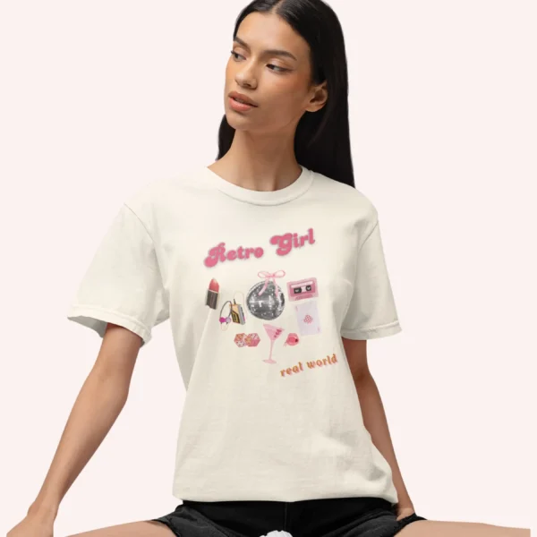 Graphic T-shirt with "Retro Girl" text in pink, paired with disco ball, lipstick, purse, martini glass, and cassette on Comfort color 1717 - Ivory