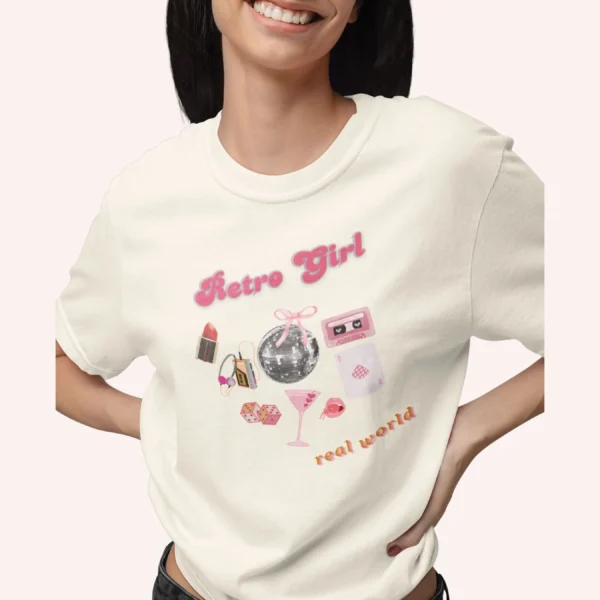 Graphic T-shirt with "Retro Girl" text in pink, paired with disco ball, lipstick, purse, martini glass, and cassette on Comfort color 1717 - Ivory Closeup