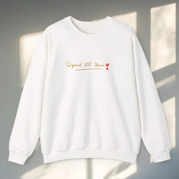 Signed, Still Yours embroidered Gildan 18000 sweatshirt by Bhoomkins - White Flatlay