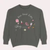 Sweatshirt with “You Look Like Poetry Today” quote and soft illustrated aesthetic elements like perfume, lipstick, ribbons, and hearts - Pepper Flatlay