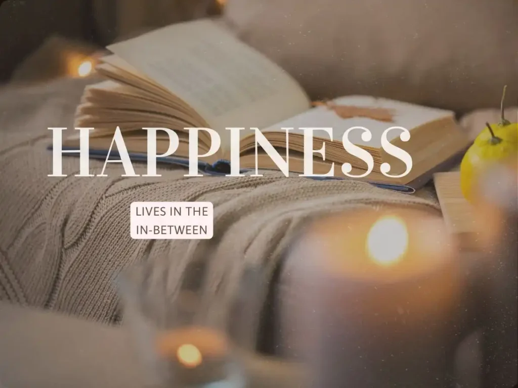 Cozy autumn aesthetic with open book, lit candle, and knitted blanket for mindful living.