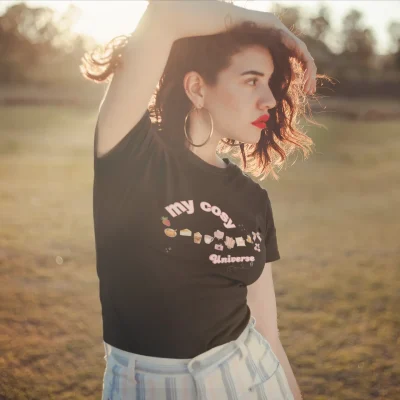 Model wearing black tee with my cozy universe design for Bhoomkins about us page